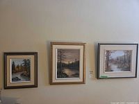 Wall view of all three framed R. Schul landscape oil paintings