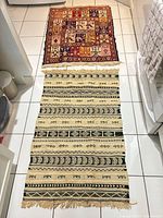 Both rugs laid out on tiled floor, full view of lot contents