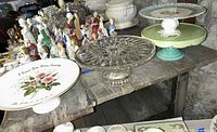 Overall view of three of the cake stands on shelf