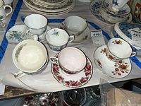 Tray showing six cup and saucer pairs in assorted floral patterns