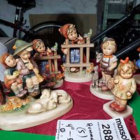 Group shot of all five Hummel porcelain figurines on display