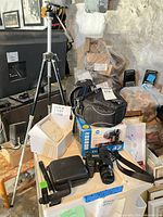 Full lot showing camera, box, bag, tripod, TourBox Elite box, flash and case