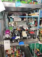 Shelf view showing all eight monster trucks