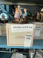 Figurine displayed atop original box