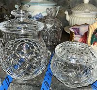 Tall and squat cut crystal jars with lids showing cut patterns