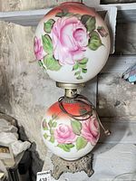 Front view of banquet lamp showing painted globes and metal base