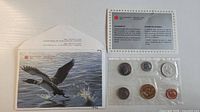 Front of envelope with common loon illustration and set contents in cellophane with information card