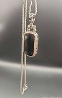 Pendant on chain showing black onyx face