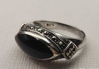 Ring side view showing black onyx cabochon and marcasite band detail