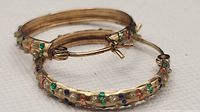 Pair of gold hoops showing crystal pattern and hinge