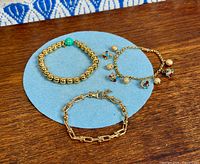 All three 18k gold-plated bracelets on display