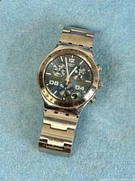 Front view of Swatch YCS438G watch showing dial, case, bracelet