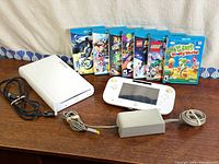 Overall view: console, GamePad, adapter, cable, seven game cases