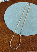 Full view of sterling silver weave link necklace laid out