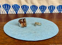 Both Swarovski rings on blue felt pad