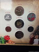 Front of sealed display showing seven coins and denominations