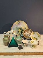 Group shot of all china, glass and metal items with ruler for scale