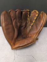 Front palm view of brown leather baseball glove