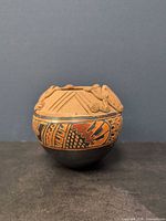 Full view of vase showing frog applique and decorative band