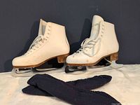 Full view of both figure skates with blades and blade covers