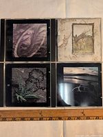 Four Led Zeppelin remastered CDs in jewel cases laid out for identification
