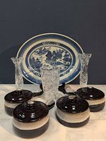 All eight pieces: blue & white platter, four stoneware casseroles with lids, two cut-crystal bud vases, one cut-crystal tumbler
