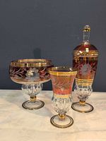 All three ruby overlay cut glass pieces grouped together