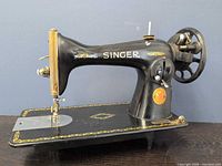 Full left side view showing entire sewing machine, decals, hand wheel and bed