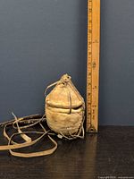 Full view of pouch beside ruler showing height and straps