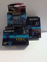 Six sealed Sony VHS-C tapes stacked showing fronts