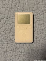 Front view of Apple iPod 3rd Gen showing screen, control buttons, scroll wheel
