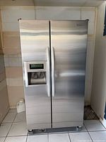 Front view of stainless refrigerator closed
