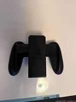 Front view of Nintendo Switch Joy-Con Grip showing logo and cradle