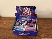 Open retail display box labelled The Azure Sea’s Seven One Piece Card Game showing stacks of cards
