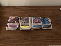 Stacks of One Piece TCG cards spread in three piles showing card fronts including King, Absalom, Edward Newgate, Ryuma