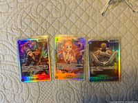 Front view of three Japanese One Piece TCG SR holo cards: Trafalgar D. Law, Shirahoshi, Monkey D. Garp