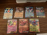 Seven Pokémon EX cards laid out on table
