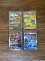 group shot of four Japanese Pokémon full art cards in toploaders