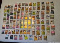 Spread of entire lot showing roughly 100 reverse holofoil Pokémon cards