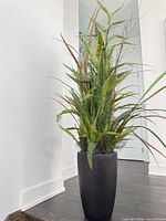 Full view of artificial plant and planter