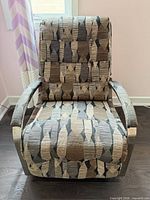 Front view of recliner upright showing upholstery pattern, metal arms