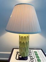 Front view of lamp showing ceramic base and fabric shade