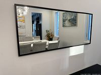 Front view of large rectangular mirror mounted on wall