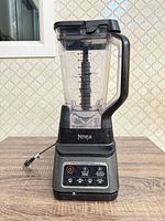 Ninja countertop blender showing jar, lid, blade assembly, power cord and control panel