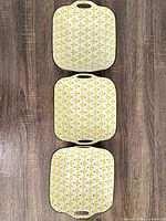 Top view of three matching handled ceramic serving bowls