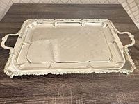 Top view of TCI silver-plated rectangular serving tray showing overall design, handles, and engraved surface