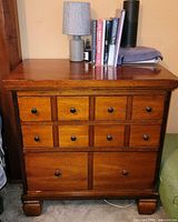 Front view of cherry finish nightstand showing drawer configuration and overall appearance