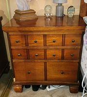 Front view of wooden nightstand showing drawers and knobs