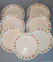 Seven dinner-size plates showing full rim pattern