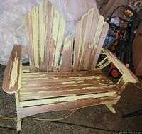 Front view of dual Adirondack rocking bench with peeling paint